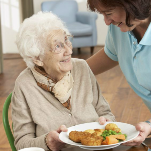 Nurse help elderly woman eat